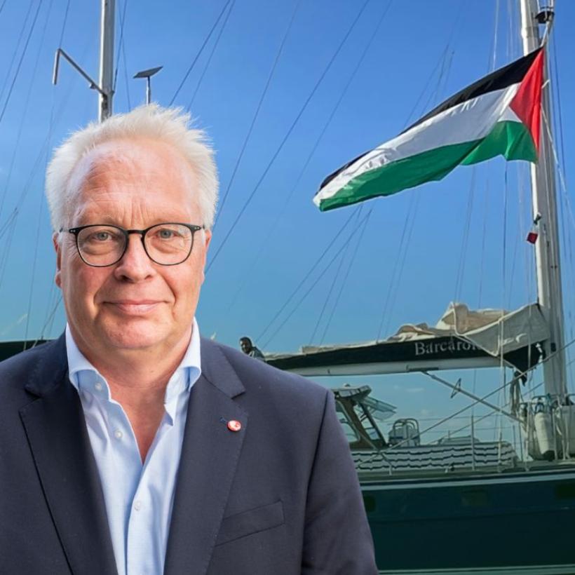 Peter Mertens met op de achtergrond een Palestijnse vlag