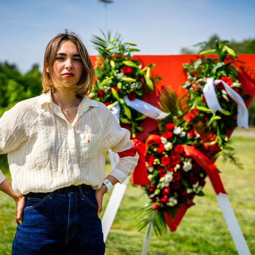 Une jeune fille pose devant un triangle rouge 
